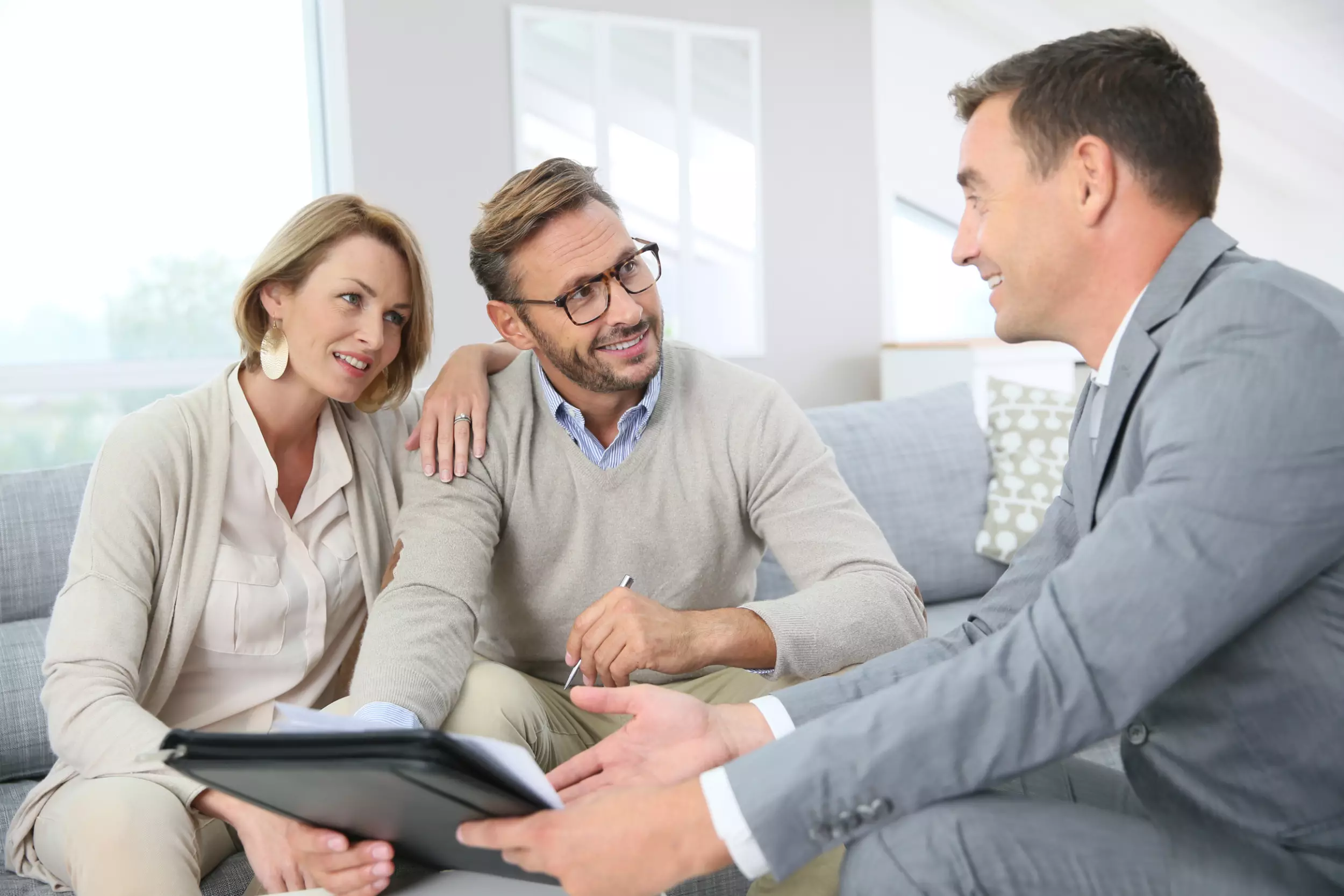 A couple going over title paperwork with an agent